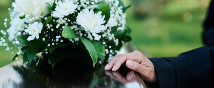 Funeral casket with a hand on top to represent wrongful death